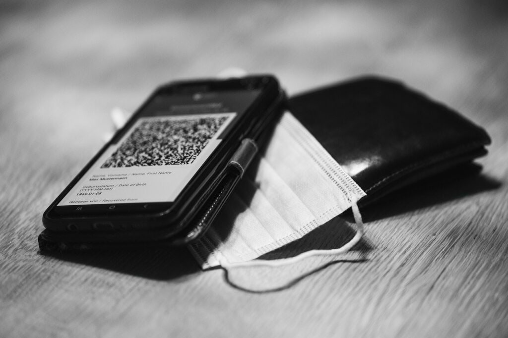 Wallet and phone with a QR code on top.